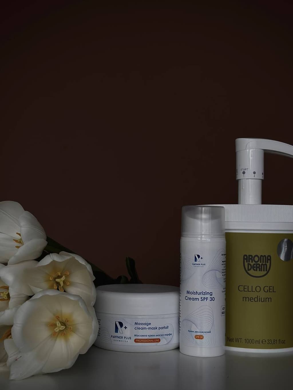 Квіти та три флакончика косметичних препаратів